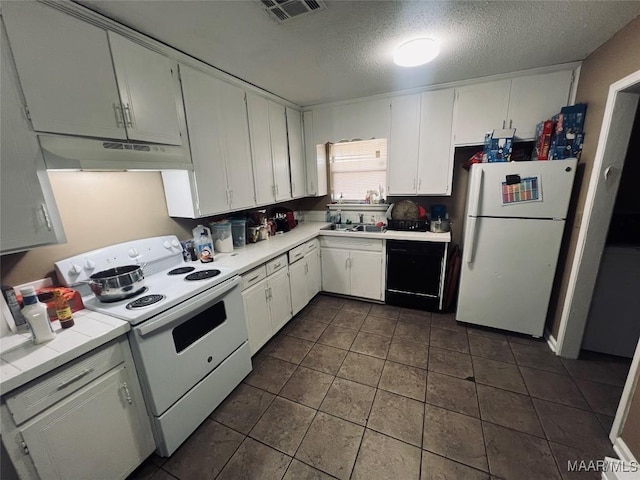 kitchen with light countertops, visible vents, white cabinetry, white appliances, and under cabinet range hood