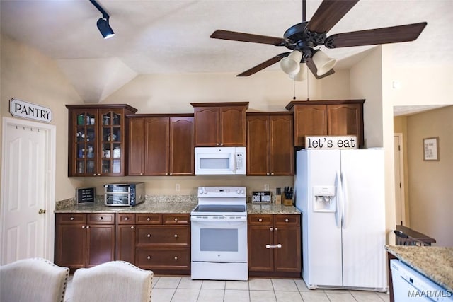 kitchen with light tile patterned floors, a toaster, white appliances, light stone countertops, and glass insert cabinets