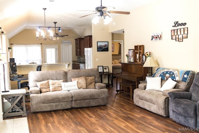 living room featuring lofted ceiling, wood finished floors, and ceiling fan with notable chandelier