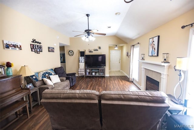 living room featuring baseboards, a ceiling fan, wood finished floors, vaulted ceiling, and a fireplace