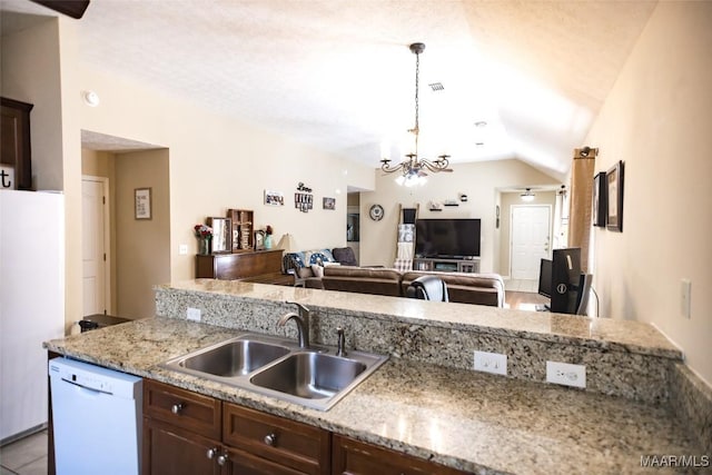 kitchen with white appliances, a sink, vaulted ceiling, dark brown cabinets, and decorative light fixtures