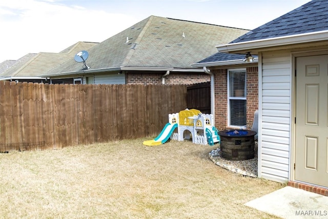 view of yard with a playground and fence