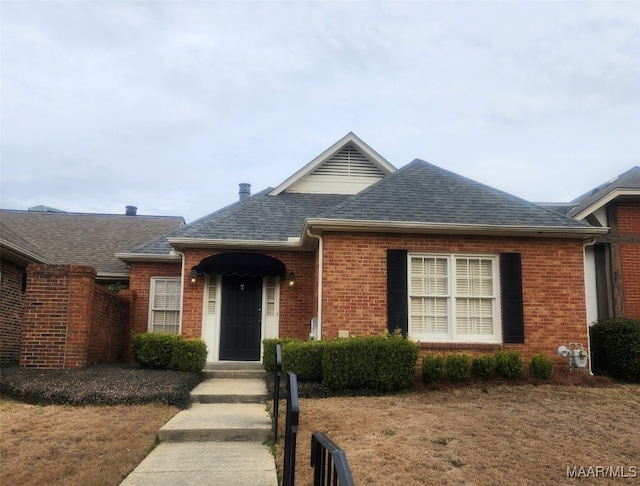 single story home with brick siding and roof with shingles