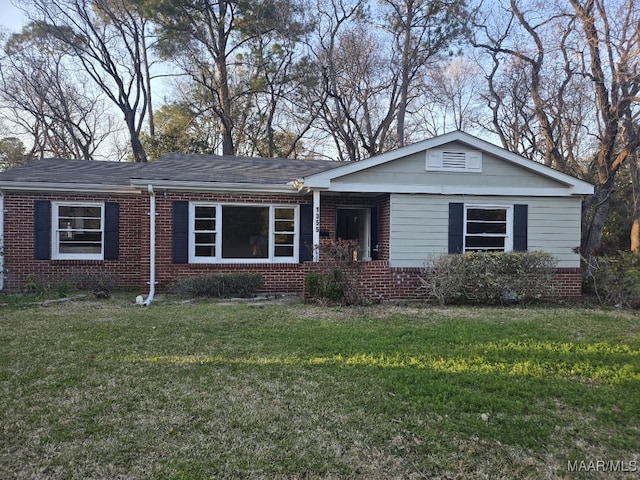 single story home with brick siding and a front lawn