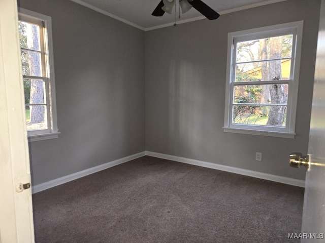 carpeted empty room featuring baseboards, a ceiling fan, and crown molding