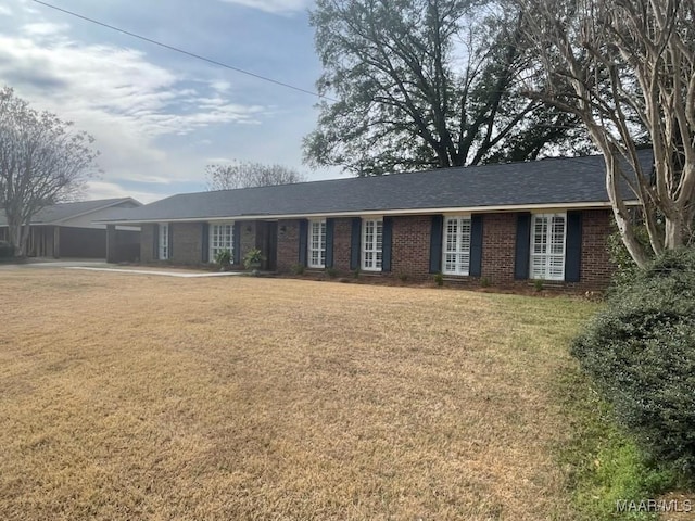 ranch-style house featuring a garage, a front yard, and brick siding