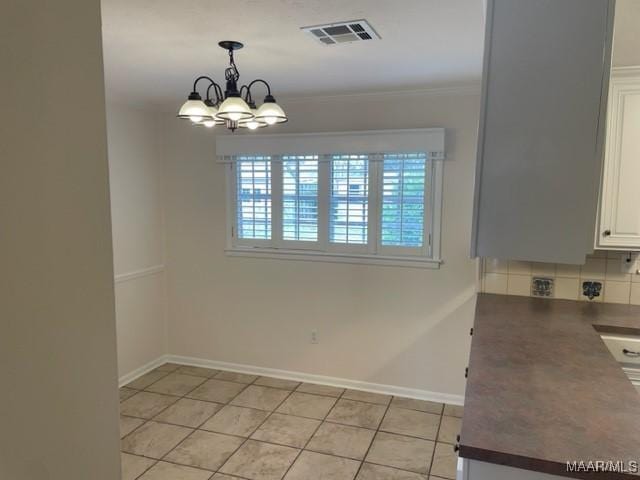 unfurnished dining area with light tile patterned floors, a wealth of natural light, visible vents, and baseboards