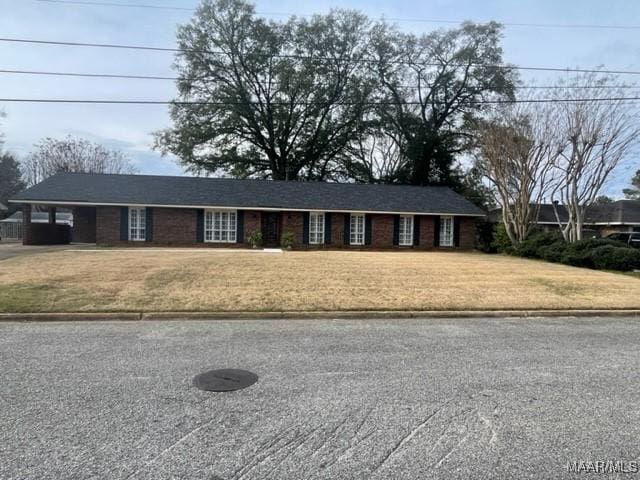 ranch-style house with a carport and a front yard