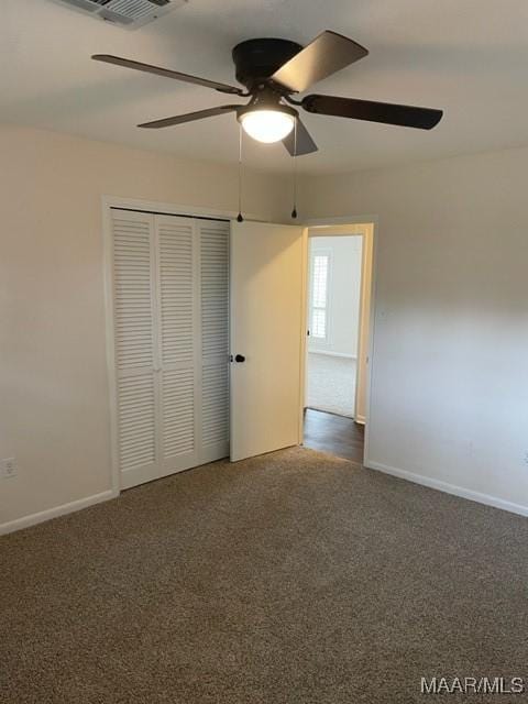 unfurnished bedroom featuring carpet floors, a closet, ceiling fan, and baseboards