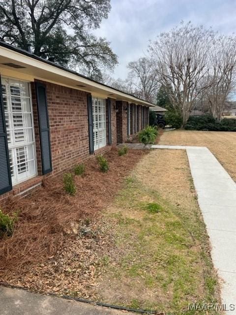 view of side of property with brick siding