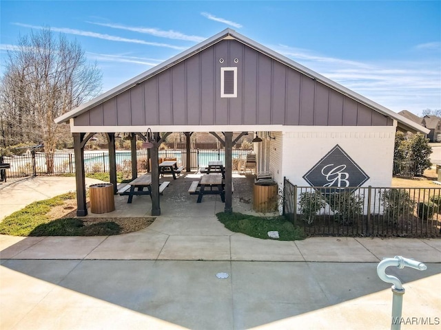 view of community with a patio area, a swimming pool, and fence