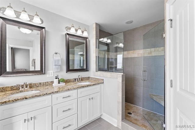 full bathroom with a stall shower, tile patterned flooring, a sink, and double vanity