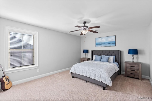 carpeted bedroom with a ceiling fan and baseboards