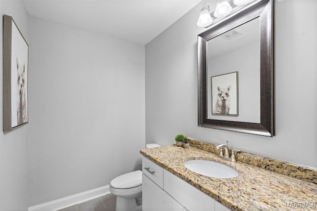 bathroom featuring visible vents, toilet, vanity, tile patterned flooring, and baseboards