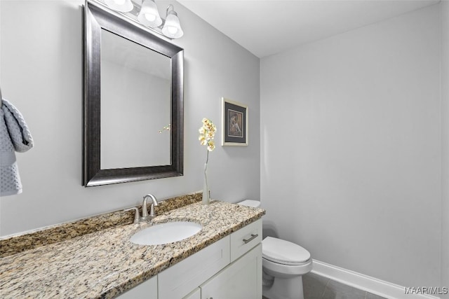 half bath featuring baseboards, vanity, toilet, and tile patterned floors