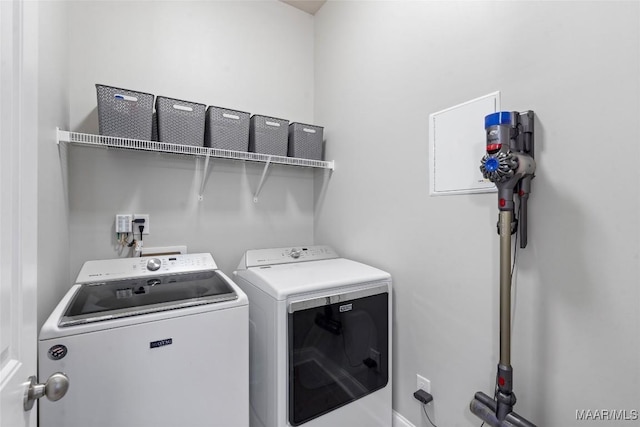 clothes washing area featuring washer and dryer and laundry area