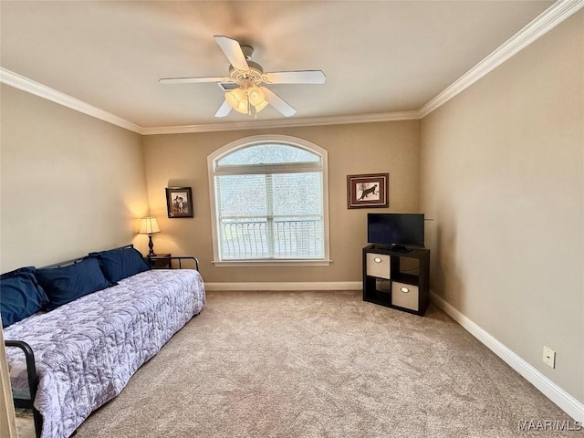 carpeted bedroom with ornamental molding, a ceiling fan, and baseboards