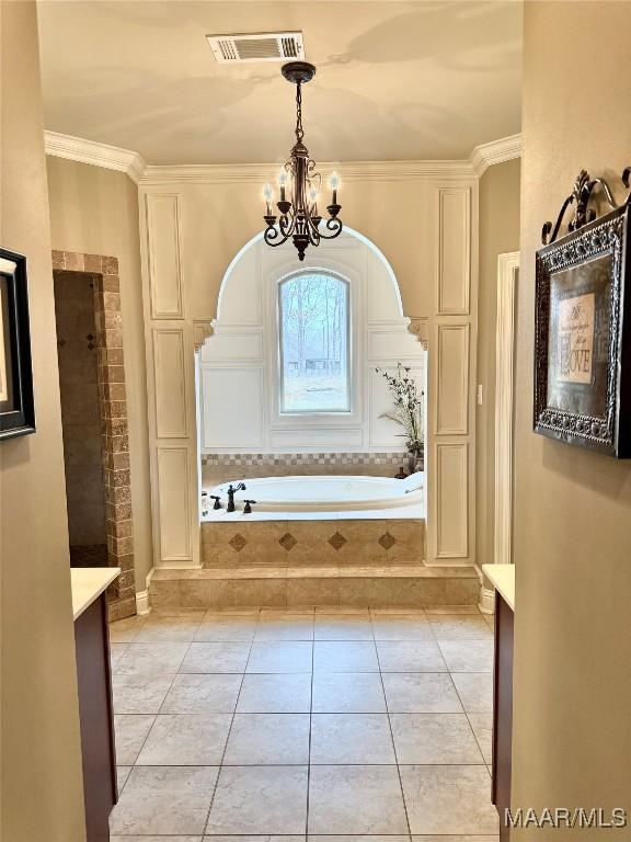 bathroom with visible vents, ornamental molding, tile patterned flooring, a chandelier, and a bath