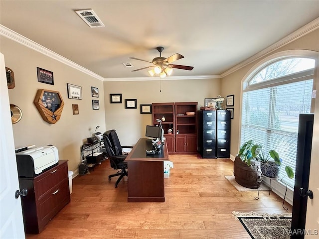 office area with visible vents, crown molding, and light wood finished floors