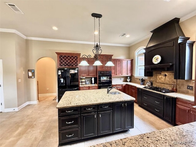 kitchen with arched walkways, visible vents, decorative backsplash, a sink, and black appliances