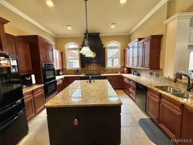 kitchen with visible vents, a kitchen island, a sink, light stone countertops, and black appliances