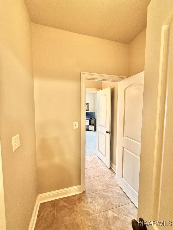 hallway featuring baseboards