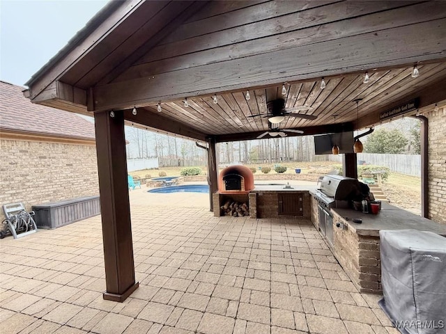 view of patio / terrace featuring a fenced in pool, area for grilling, a fenced backyard, ceiling fan, and a grill