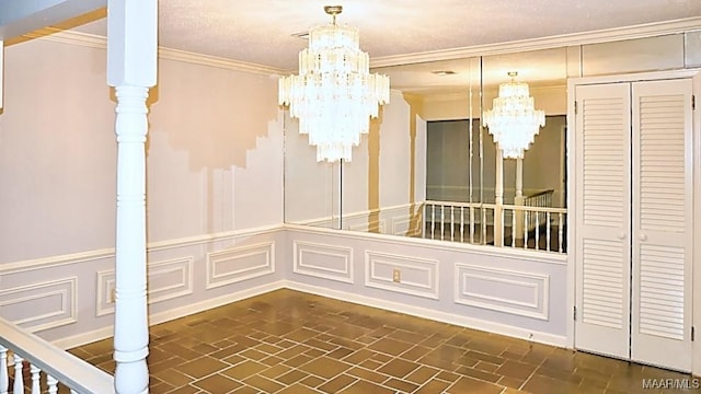 interior space featuring brick floor, a chandelier, a decorative wall, and crown molding