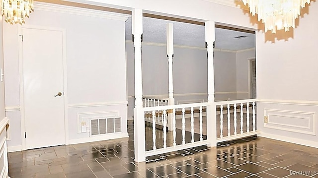 interior space with a wainscoted wall, visible vents, a decorative wall, stairway, and ornamental molding