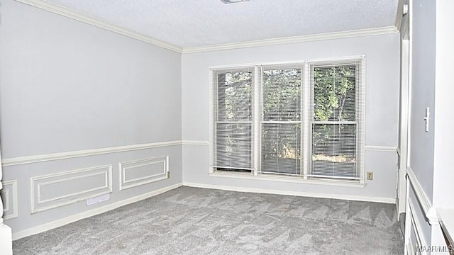 carpeted empty room with a textured ceiling and crown molding