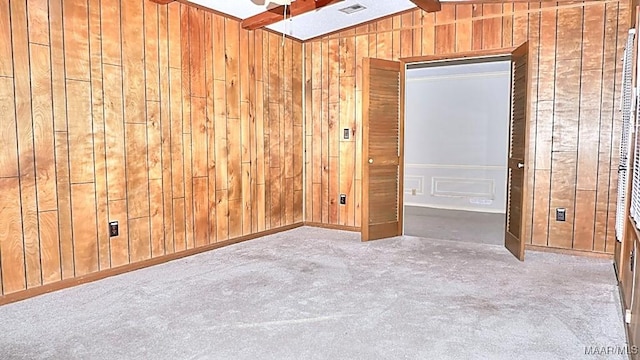 spare room with wood walls