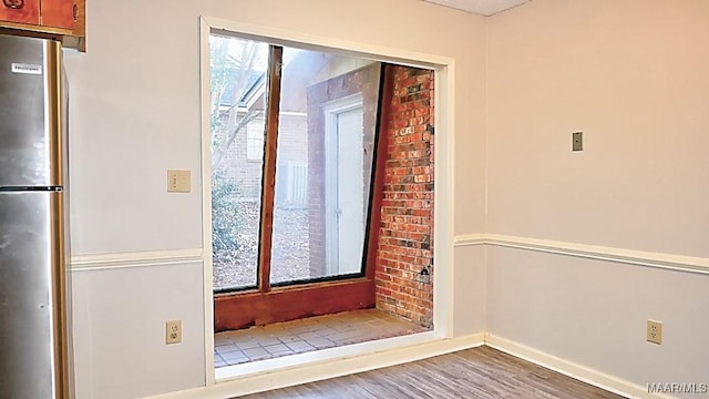 spare room featuring wood finished floors