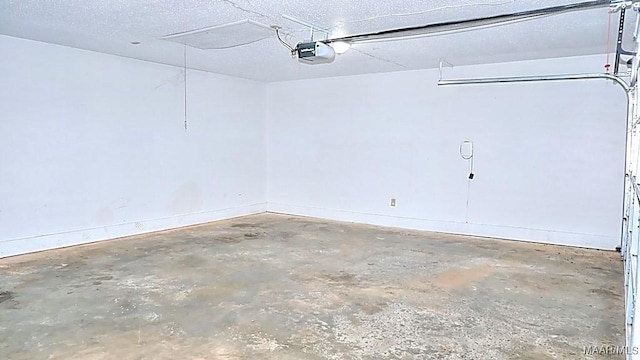 garage with baseboards and a garage door opener