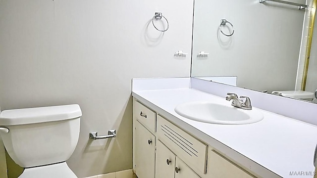 bathroom featuring toilet and vanity