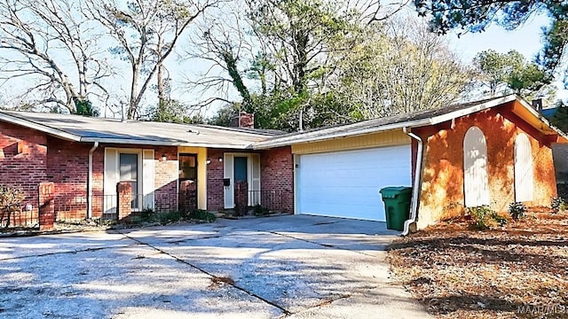 ranch-style house featuring driveway, an attached garage, a chimney, and brick siding