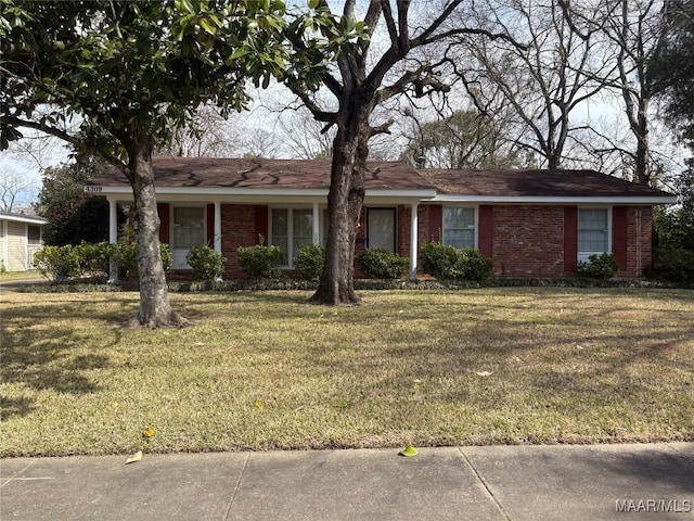 ranch-style home featuring brick siding and a front yard