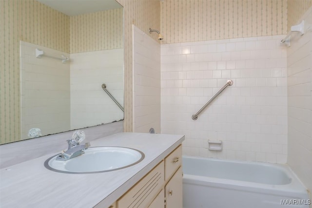 full bathroom with shower / washtub combination, vanity, and wallpapered walls