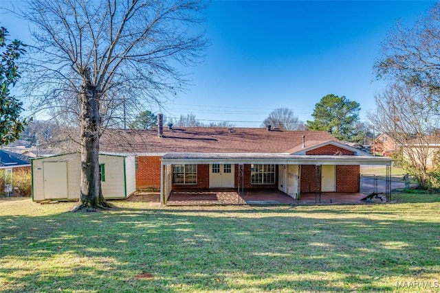 back of house with a patio, brick siding, an outdoor structure, a lawn, and a shed