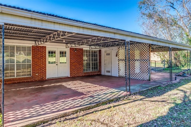 exterior space featuring a carport, french doors, and driveway