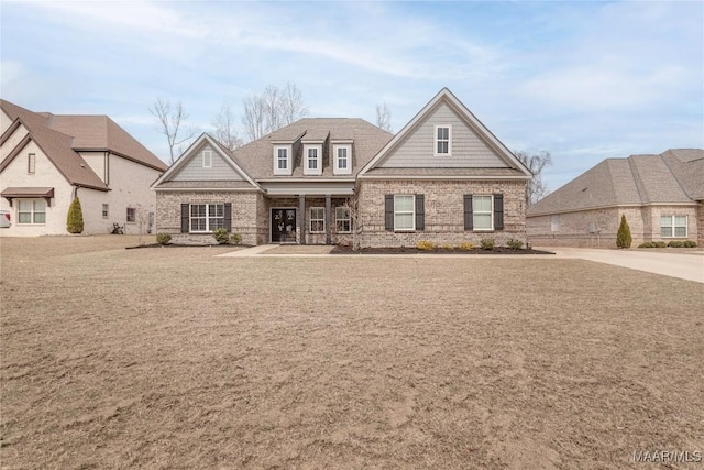 view of front of home featuring brick siding and a front lawn