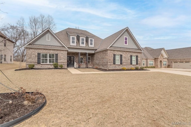 craftsman-style home featuring brick siding and a shingled roof