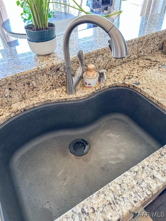 details with stone countertops and a sink