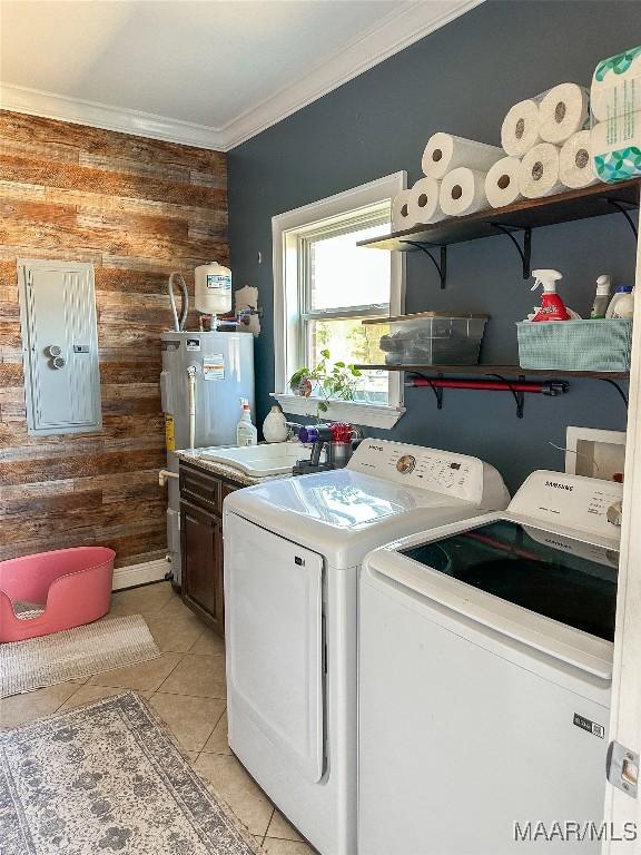 laundry room with cabinet space, crown molding, light tile patterned floors, and washer and dryer