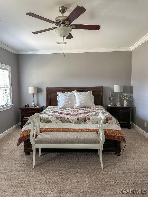 bedroom featuring crown molding, light colored carpet, visible vents, ceiling fan, and baseboards