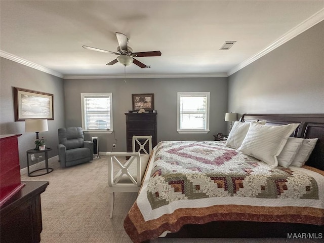 carpeted bedroom with baseboards, multiple windows, visible vents, and crown molding