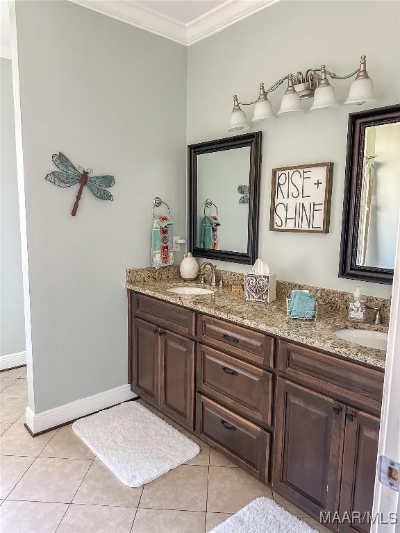 full bathroom featuring crown molding, a sink, and tile patterned floors