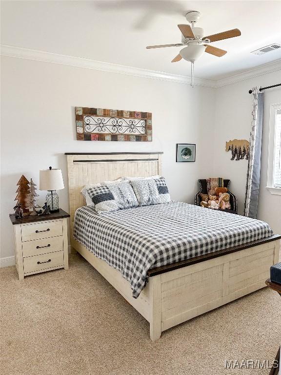 bedroom featuring light carpet, a ceiling fan, visible vents, and crown molding