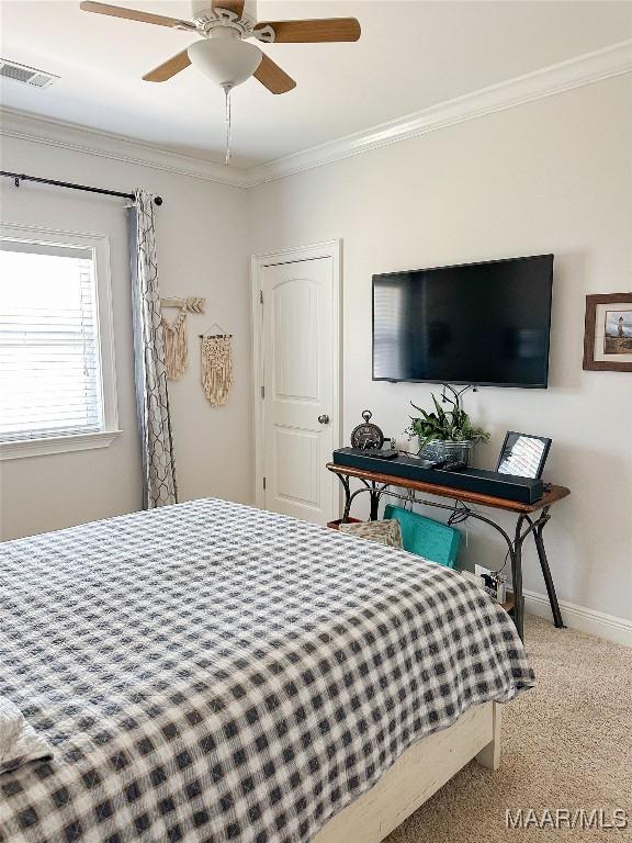 bedroom featuring visible vents, baseboards, ceiling fan, ornamental molding, and carpet