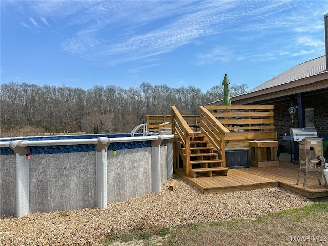 pool with a deck and area for grilling