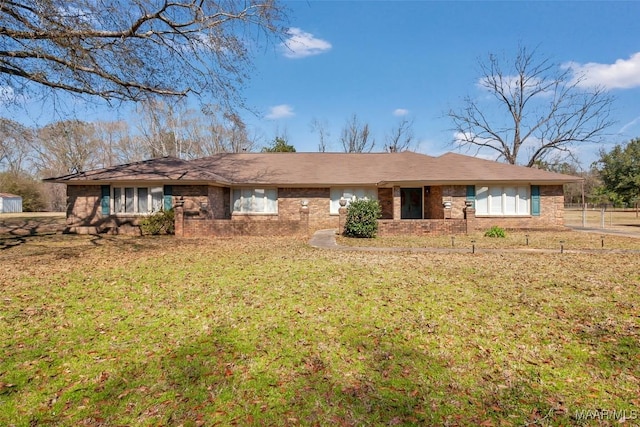 ranch-style home with a front lawn and brick siding